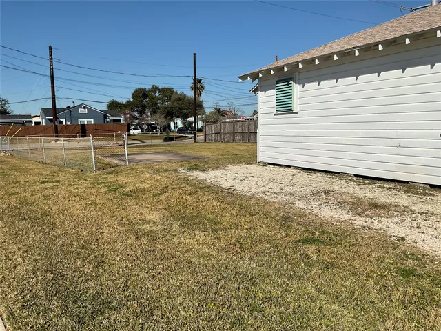 a kitchen with granite countertop a refrigerator and cabinets