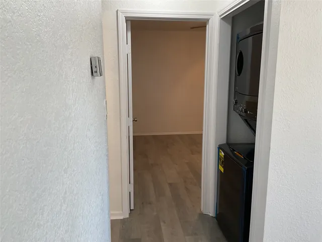 an empty room with wooden floor and closet area