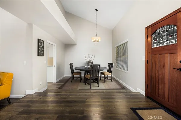 a bedroom with a bed and a large window with couch