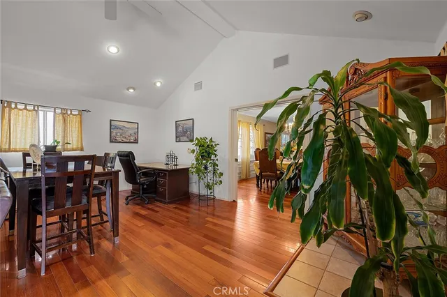 a view of a hallway with wooden floor and entryway