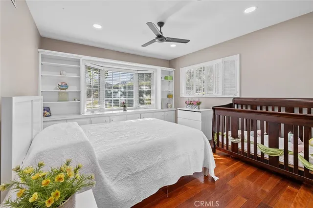 a living room with furniture a flat screen tv and a floor to ceiling window
