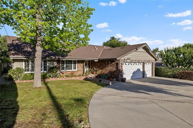 a view of a house with yard and sitting area