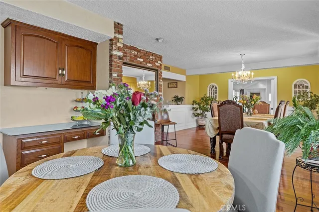 a living room with dining room and wooden floor