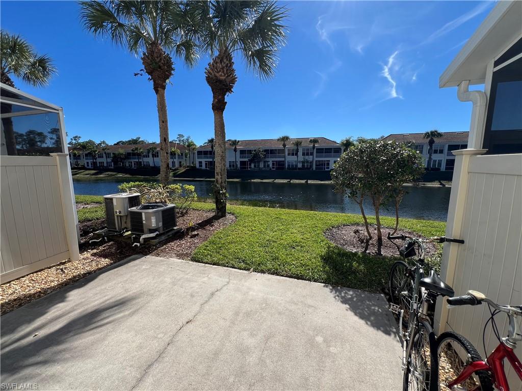 972 Hampton Circle, Unit 77 Naples, FL 34105 - Photo 11 of 24 a view of a lake with a house in the background
