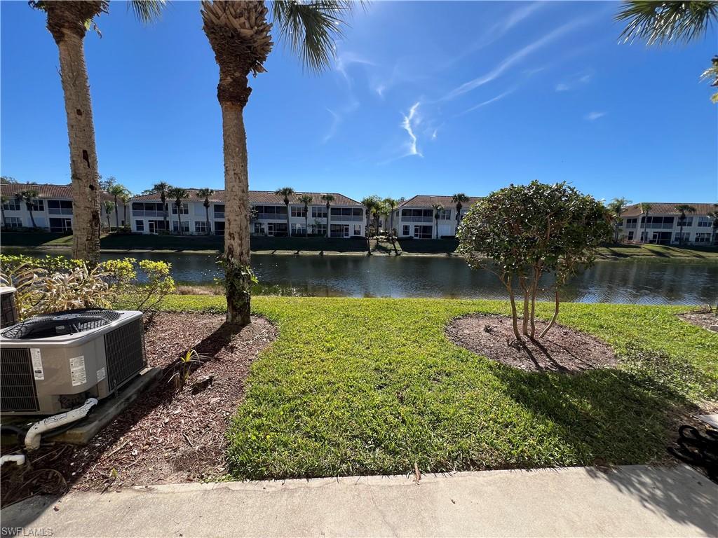 972 Hampton Circle, Unit 77 Naples, FL 34105 - Photo 13 of 24 a view of a lake with houses