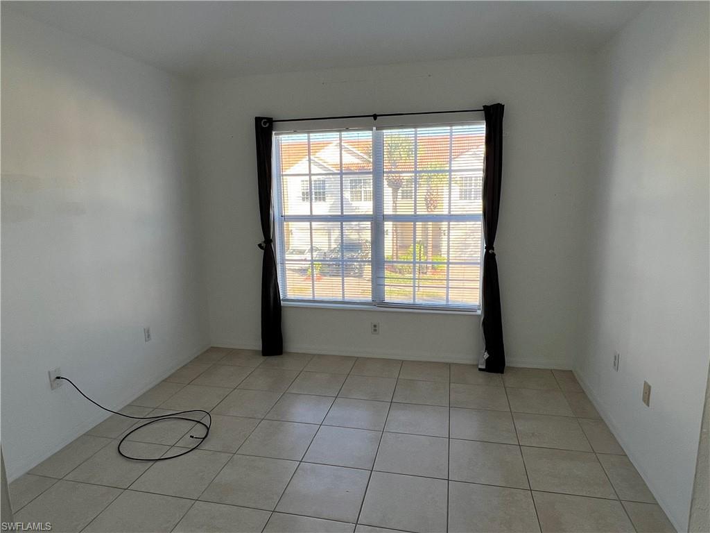 972 Hampton Circle, Unit 77 Naples, FL 34105 - Photo 18 of 24 a view of an empty room with a window