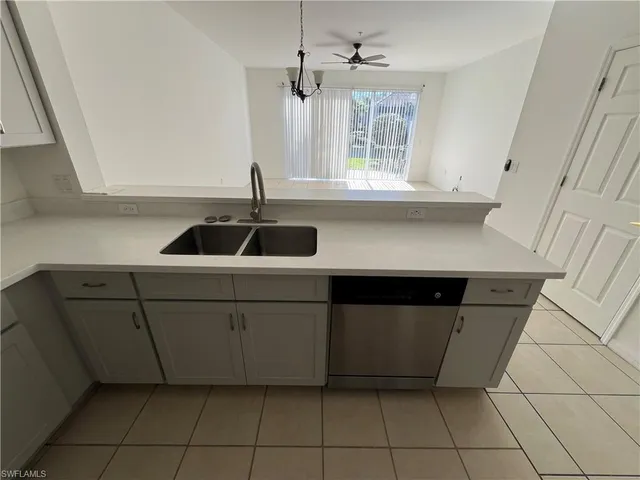 a kitchen with cabinets and window