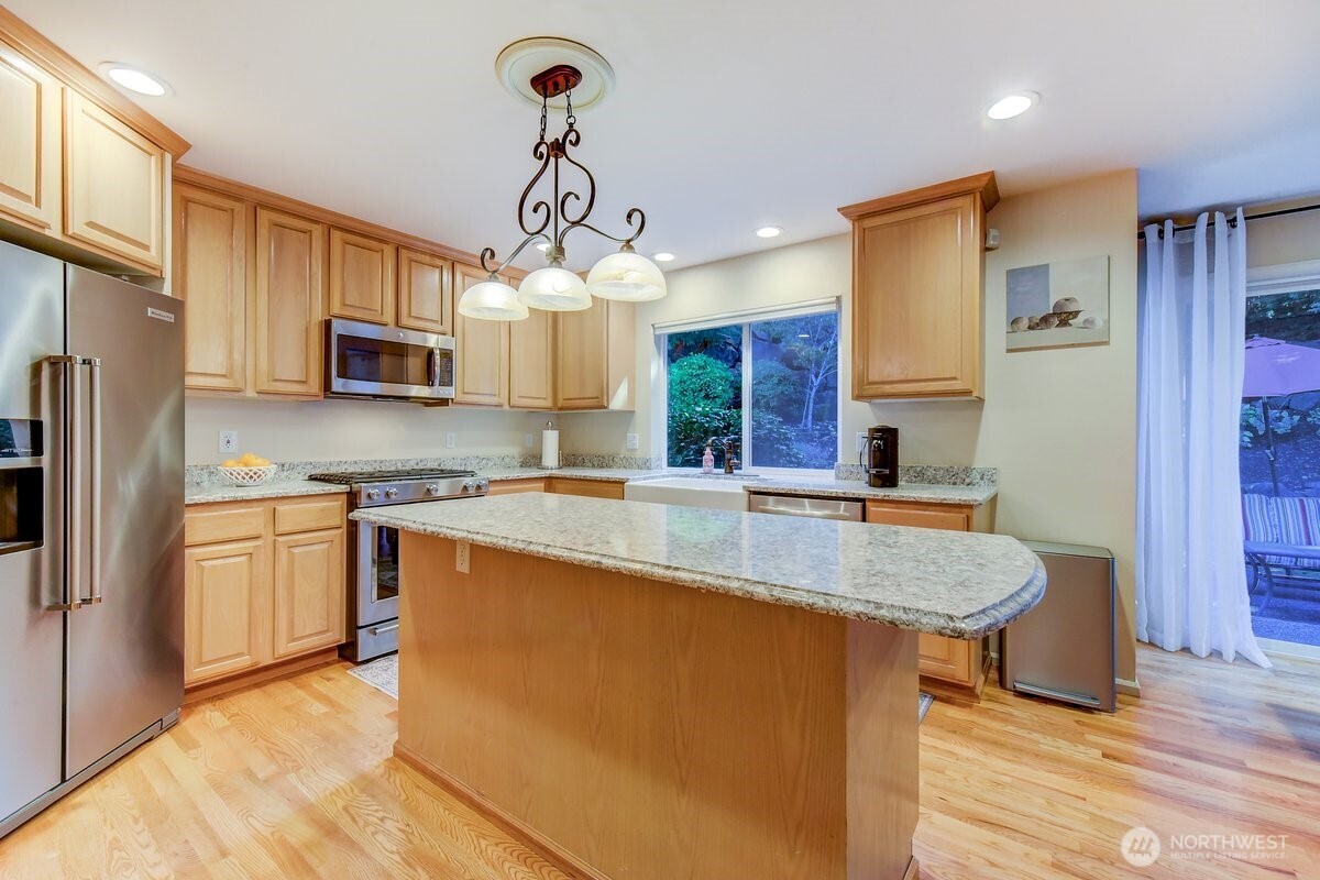 20019 27th Drive Southeast Bothell, WA 98012 - Photo 11 of 36 a large kitchen with stainless steel appliances granite countertop a sink a stove and refrigerator
