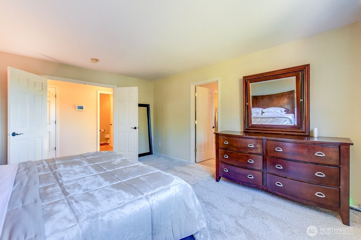 20019 27th Drive Southeast Bothell, WA 98012 - Photo 17 of 36 a bedroom with a bed and a mirror