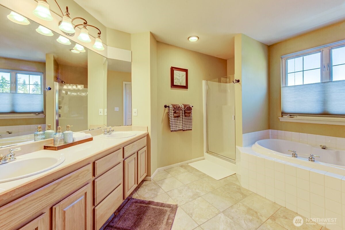 20019 27th Drive Southeast Bothell, WA 98012 - Photo 20 of 36 a bathroom with a tub sink and mirror