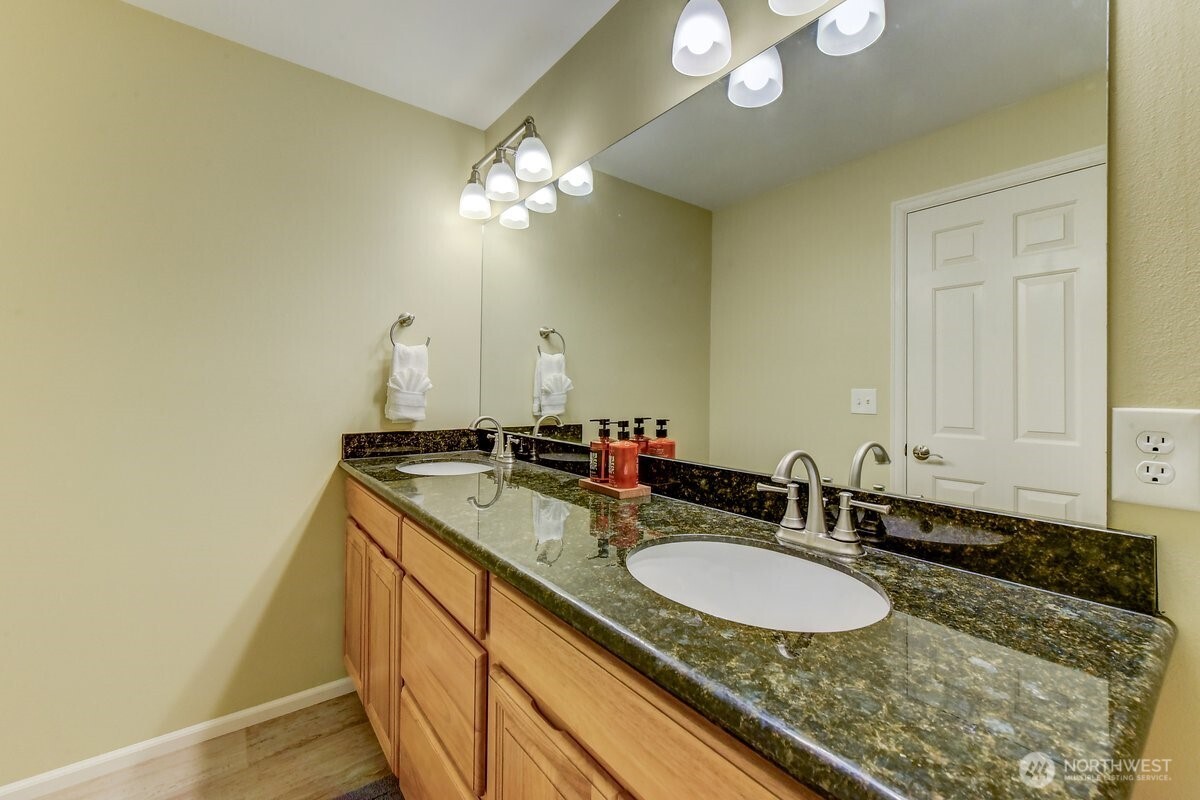 20019 27th Drive Southeast Bothell, WA 98012 - Photo 24 of 36 a bathroom with a granite countertop double vanity and a mirror
