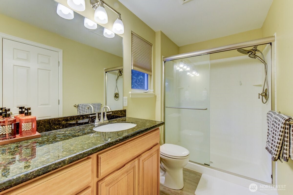 20019 27th Drive Southeast Bothell, WA 98012 - Photo 25 of 36 a bathroom with a granite countertop sink toilet and shower