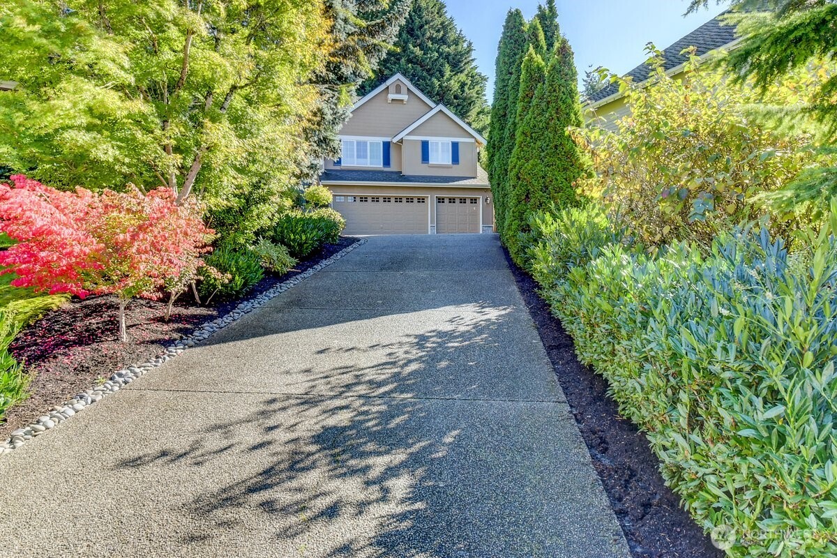 20019 27th Drive Southeast Bothell, WA 98012 - Photo 3 of 36 a front view of a house with a yard and garage