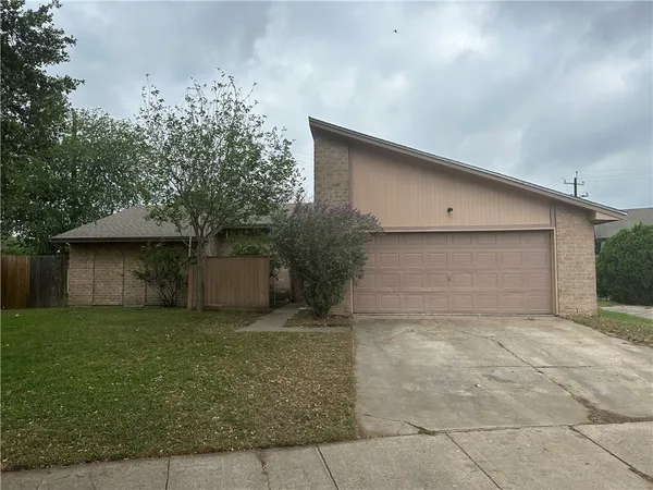 a view of a house with a yard and garage