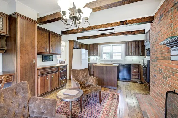 a living room with stainless steel appliances kitchen island granite countertop furniture and a kitchen view