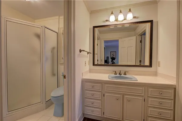 a bathroom with a sink vanity granite and a mirror