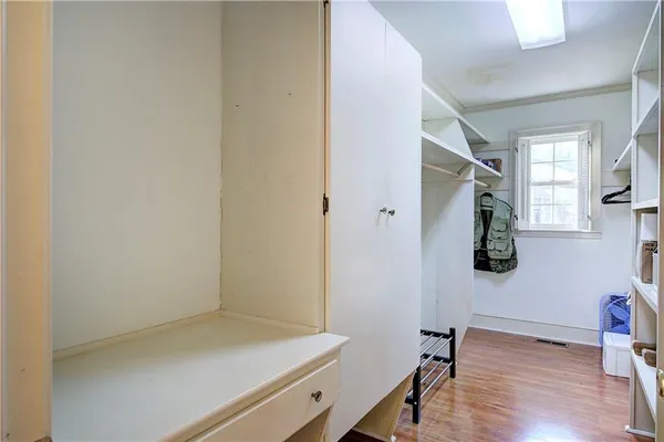 a bathroom with a granite countertop sink a toilet and a window