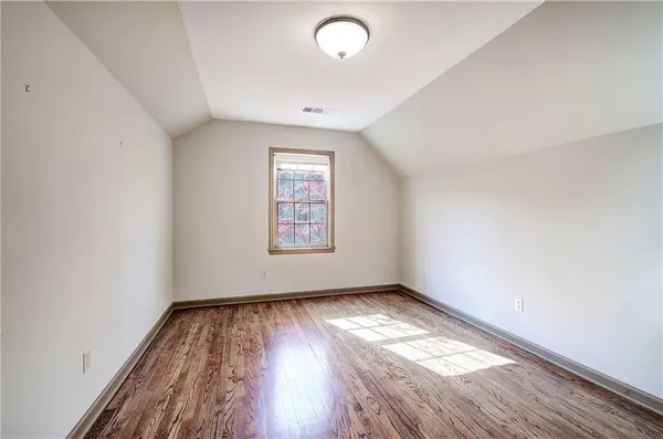 a view of an empty room with a fireplace