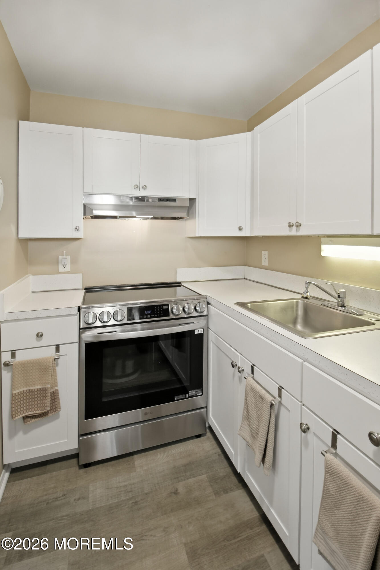 22 A Roosevelt City Road Whiting, NJ 08759 - Photo 7 of 18 a kitchen with white cabinets and appliances