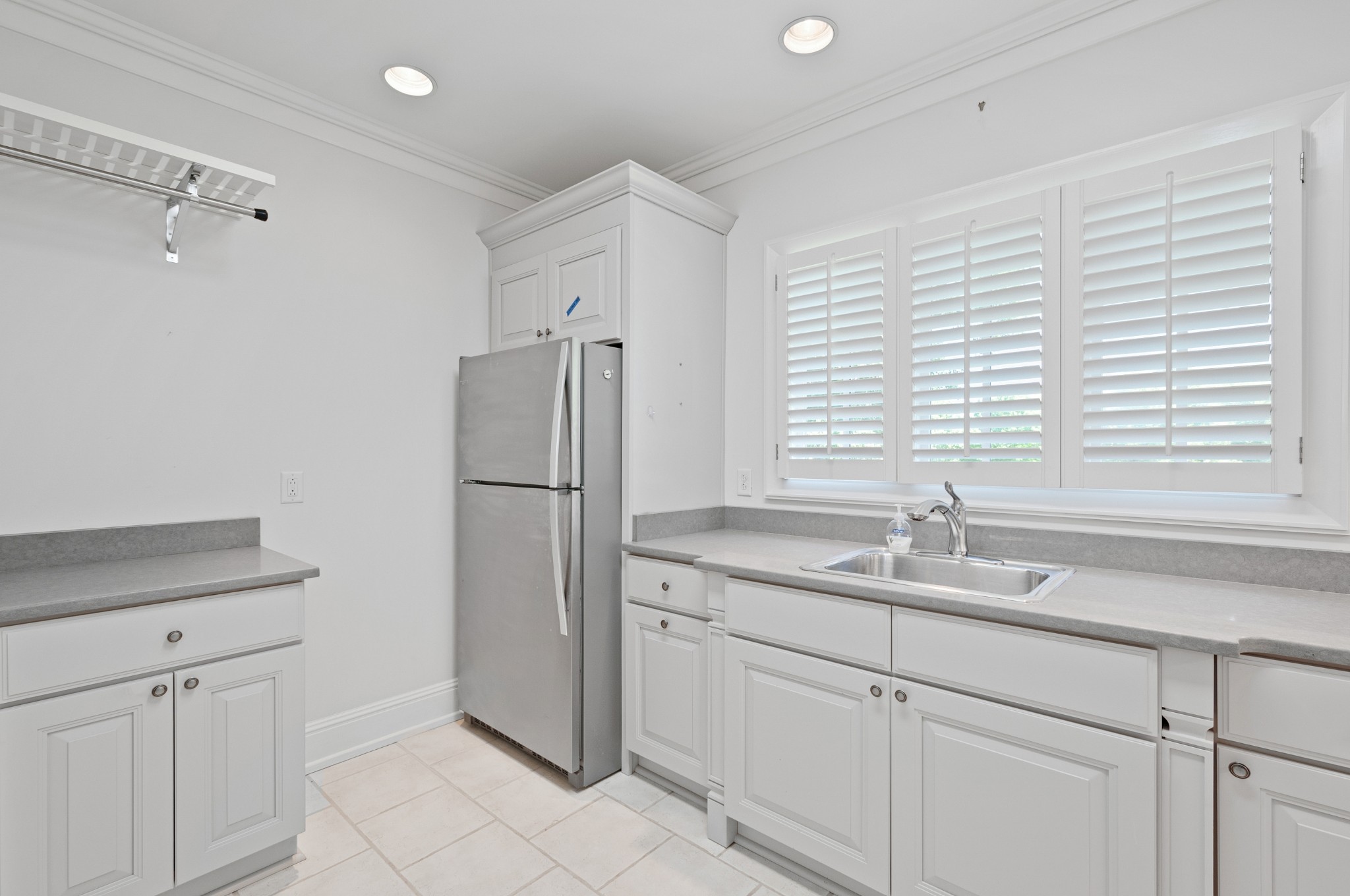 4816 Post Road Nashville, TN 37205 - Photo 32 of 54 a kitchen with a sink a refrigerator a window and cabinets