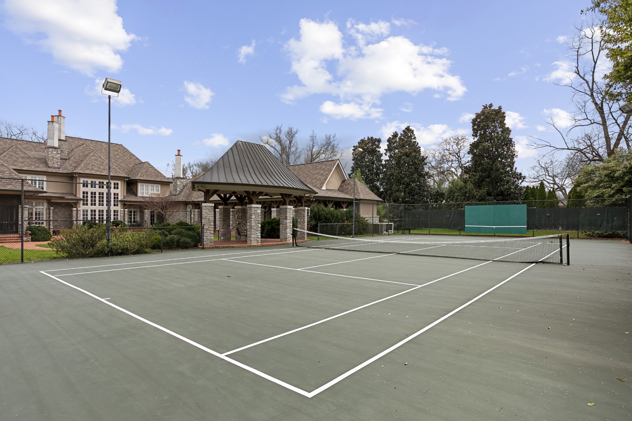 4816 Post Road Nashville, TN 37205 - Photo 43 of 54 a view of a tennis ground with a large tree in the center