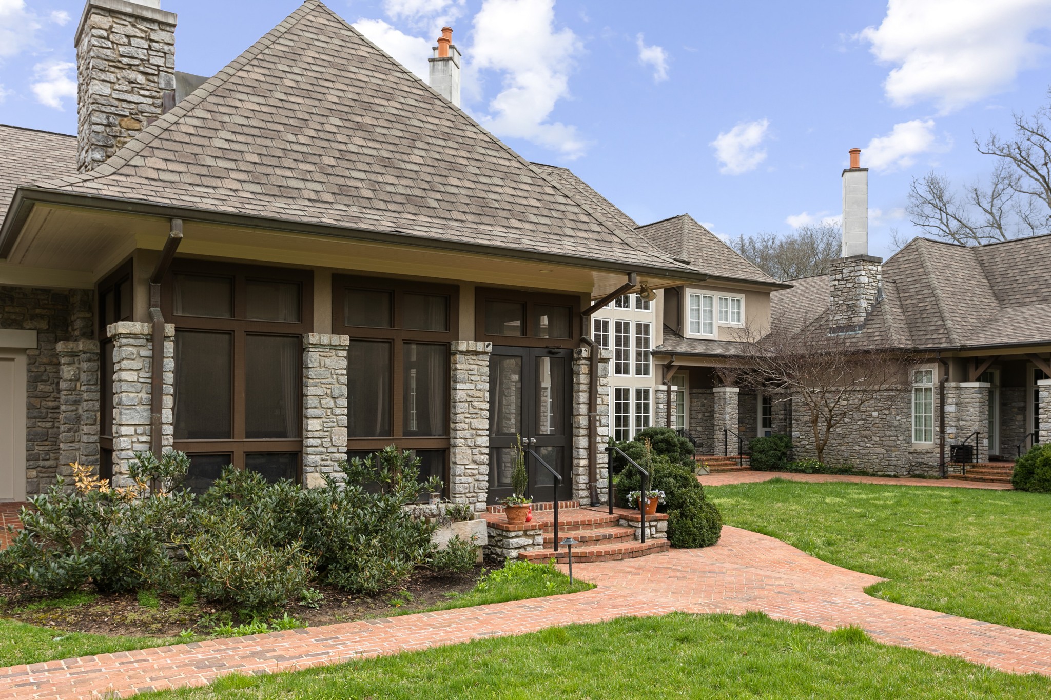 4816 Post Road Nashville, TN 37205 - Photo 45 of 54 a view of a house with brick walls and a yard with plants