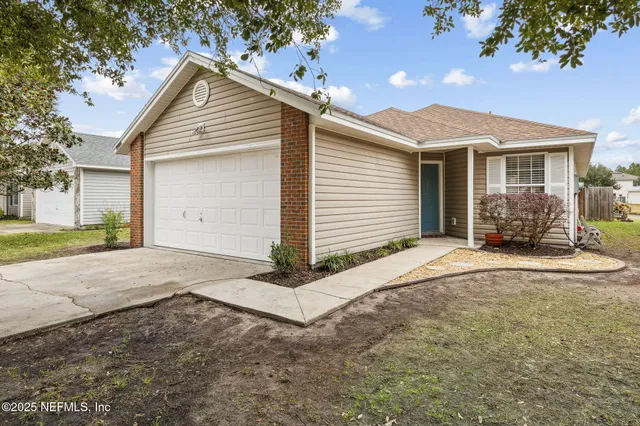 a view of a house with a yard and garage