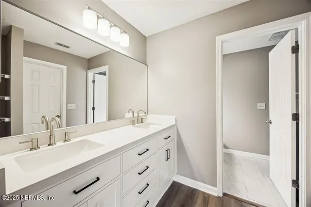 a bathroom with a sink double vanity and a mirror