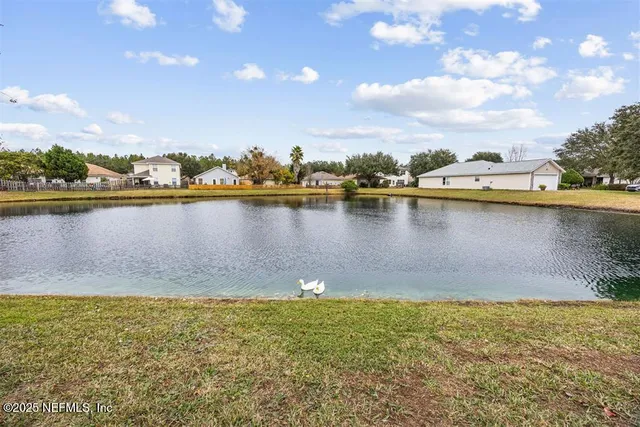 a view of a lake with houses in the back