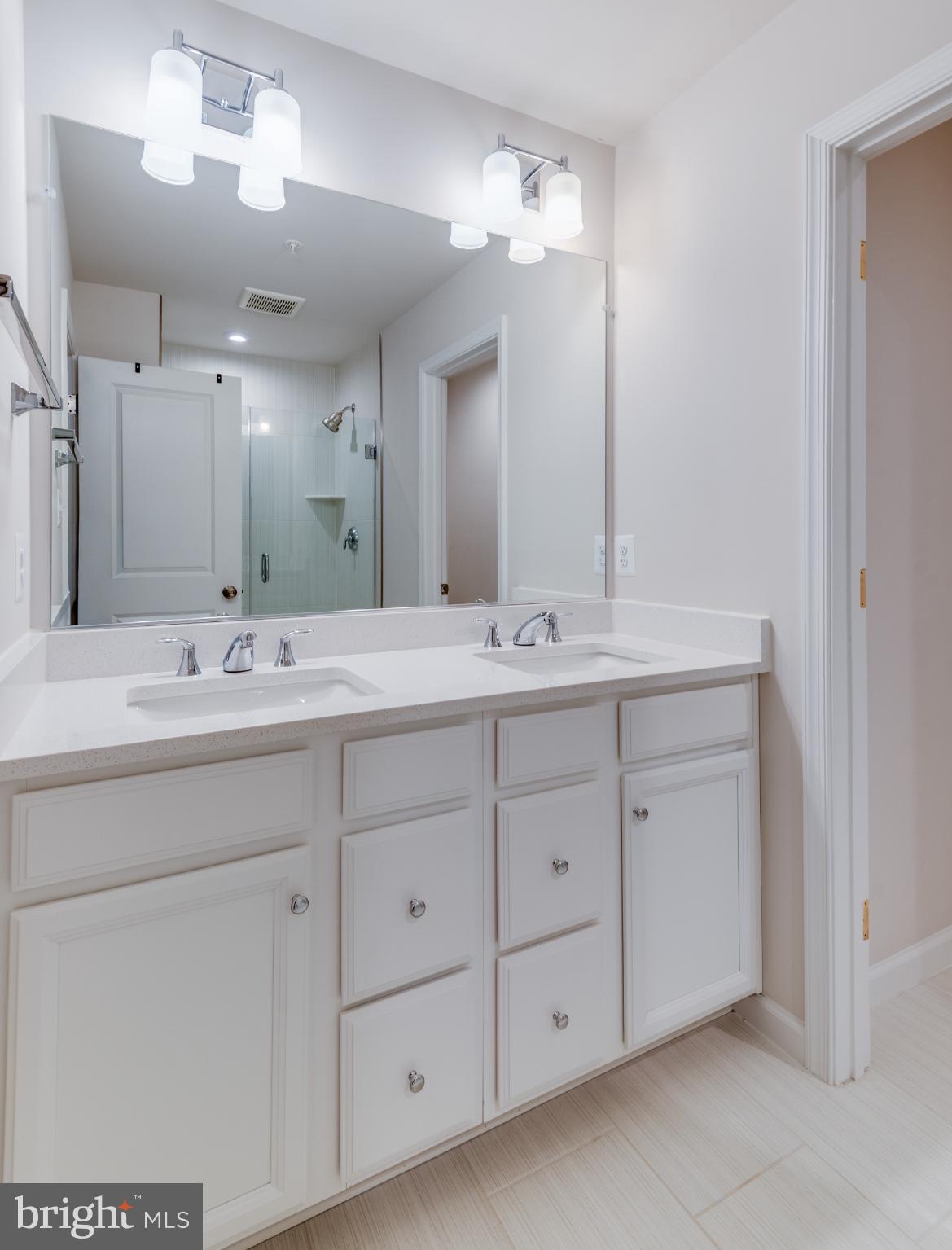 44596 Nolani Way California, MD 20619 - Photo 28 of 31 a bathroom with double sink and a mirror