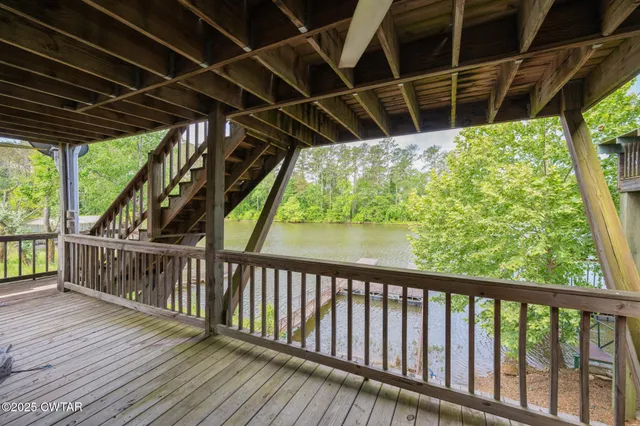 an aerial view of a house with a garden and lake view
