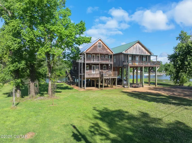 a view of a balcony with a large window and wooden floor
