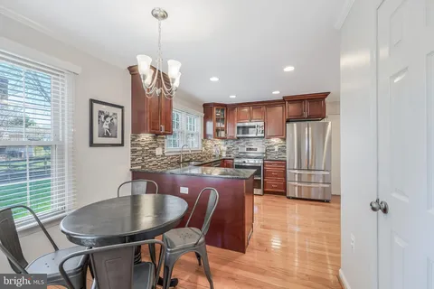 a kitchen with stainless steel appliances granite countertop wooden cabinets a sink and a stove