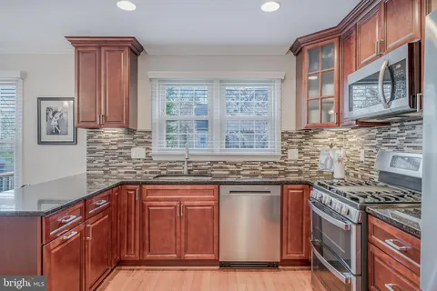 a view of a hallway with bathroom and wooden floor