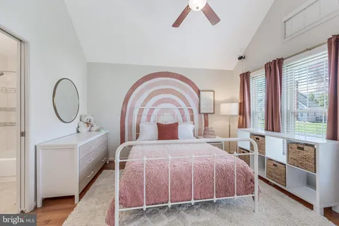 a spacious bedroom with a large bed and a chandelier