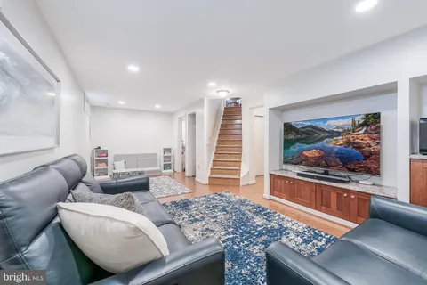 a living room with furniture and a book shelf