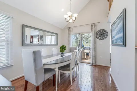 a view of a dining room with furniture kitchen and wooden floor