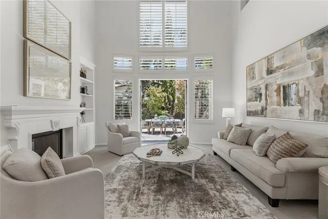a living room with furniture a chandelier a rug and a window