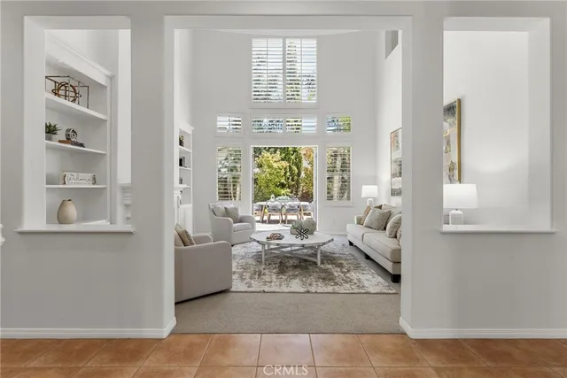 a living room with furniture and a dining table with kitchen view