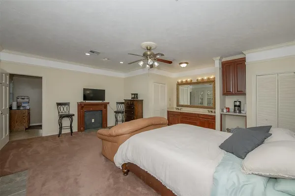 a spacious bedroom with a bed and a chandelier