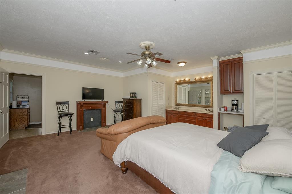 1332 Highway 14 Kosse, TX 76653 - Photo 32 of 40 a spacious bedroom with a bed and a chandelier