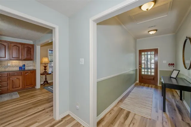 a view of a hallway with wooden floor and a fireplace