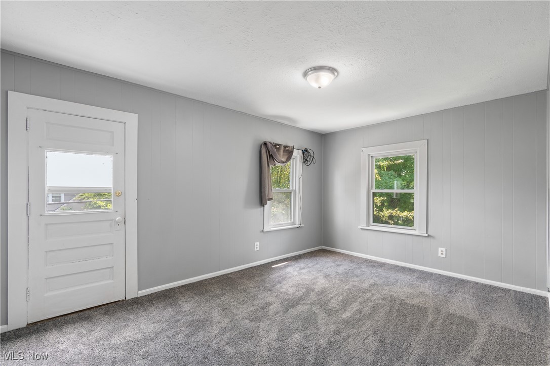 302 Poplar Avenue Northwest Canton, OH 44708 - Photo 17 of 34 Carpeted empty room with a textured ceiling and baseboards