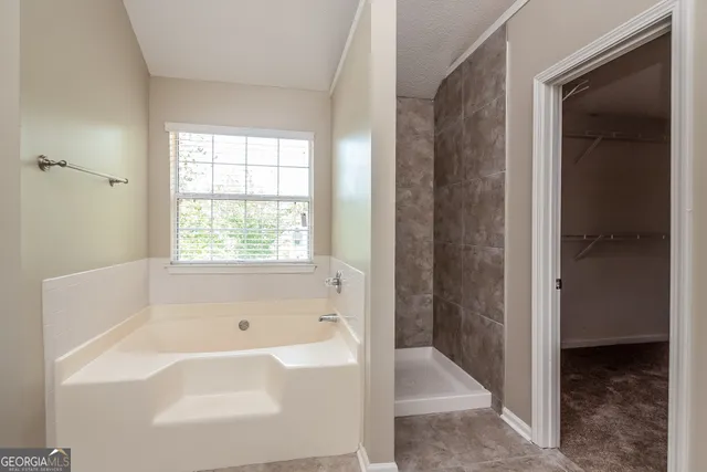 a bathroom with a bathtub and shower