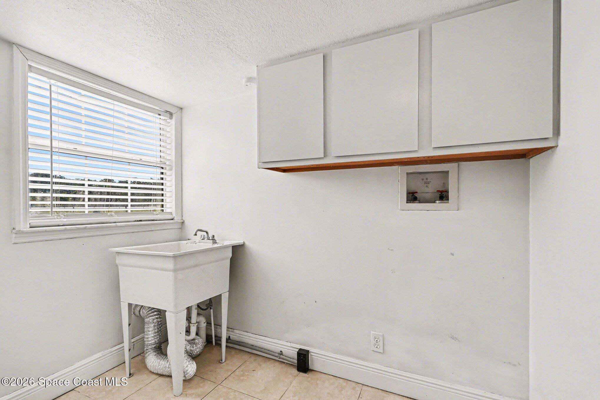 4950 Blounts Ridge Road Mims, FL 32754 - Photo 26 of 40 a bathroom with a sink and a window