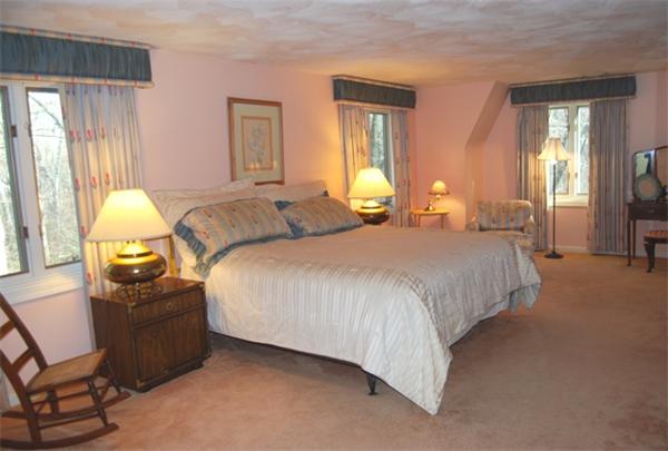 237 East Emerson Road Lexington, MA 02420 - Photo 15 of 22 a bed room with a bed and a lamp