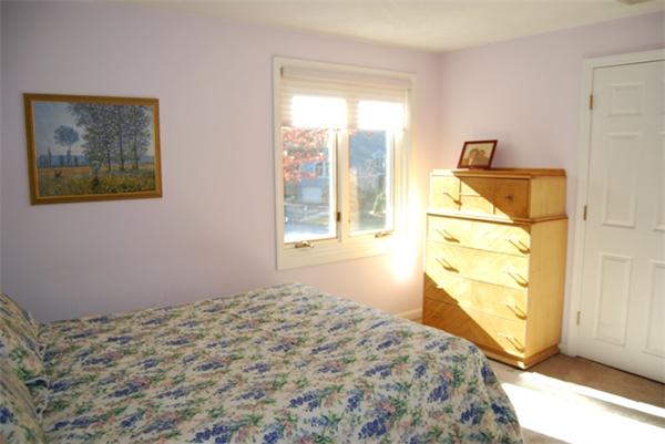 237 East Emerson Road Lexington, MA 02420 - Photo 18 of 22 a bedroom with a bed and wooden floor