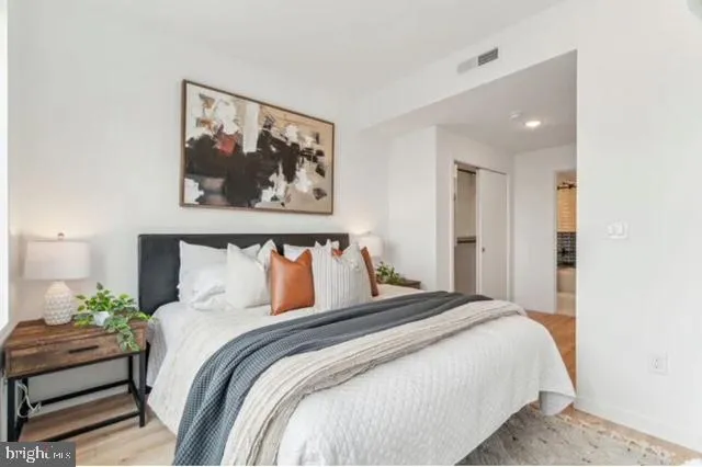 a bedroom with a bed and a couch