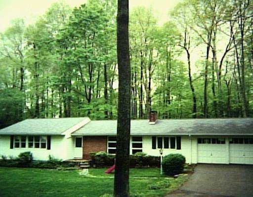 104 Poplar Road Ridgefield, CT 06877 - Photo 1 of 1 a view of a white house with a big yard plants and large trees