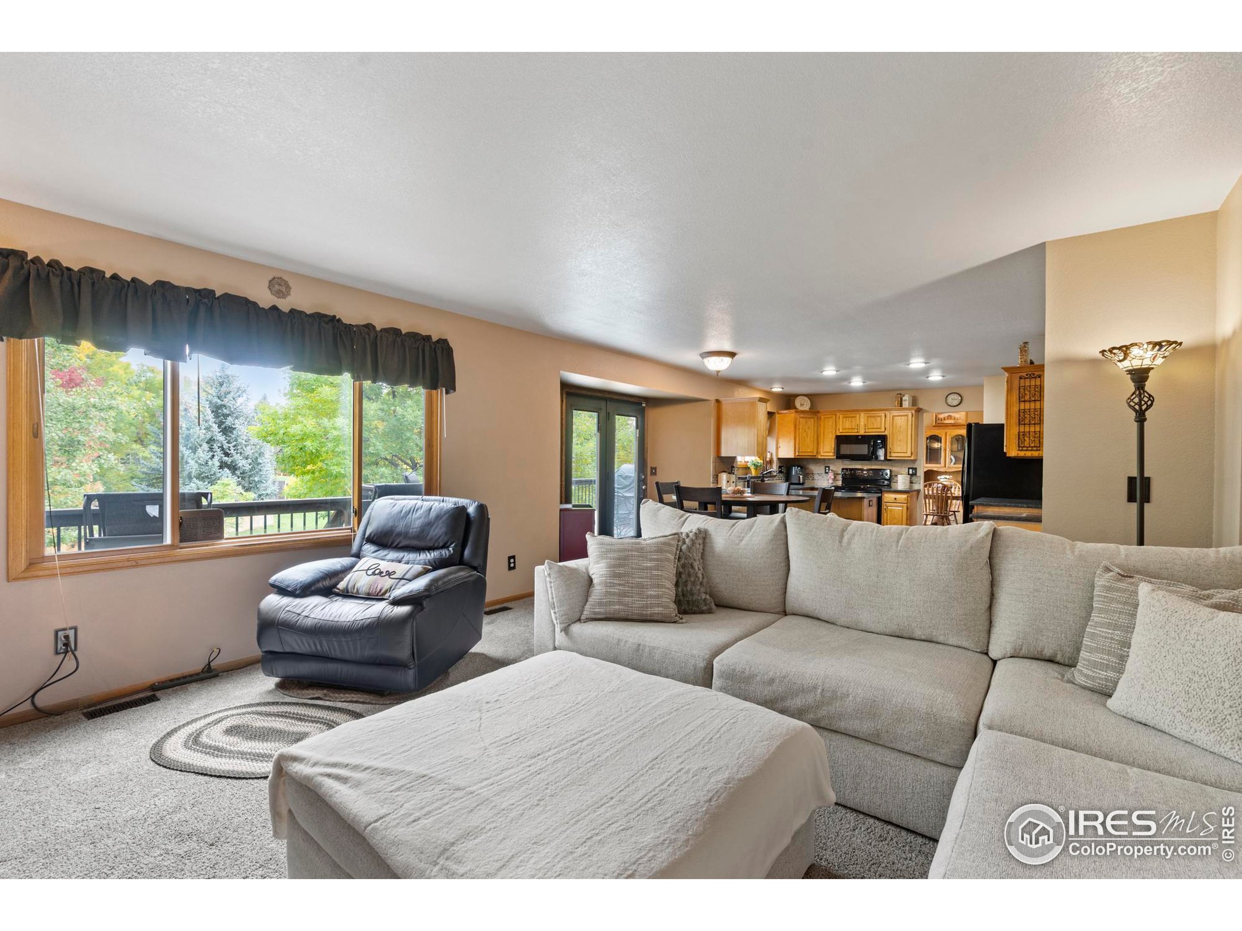 1808 Silvergate Road Fort Collins, CO 80526 - Photo 16 of 42 a living room with furniture and a large window